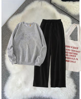 Grey sweatshirt and black flapper (track suit)
